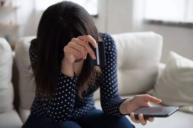 Upset woman feel stressed having problems paying on cellphone with bank credit card.