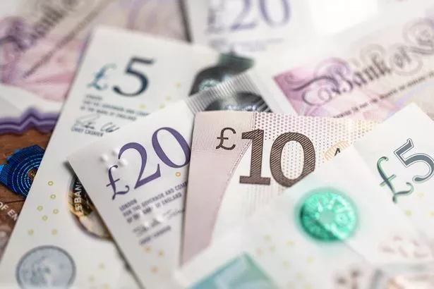 Different denominations of British PoundNotes with newly minted one pound coins