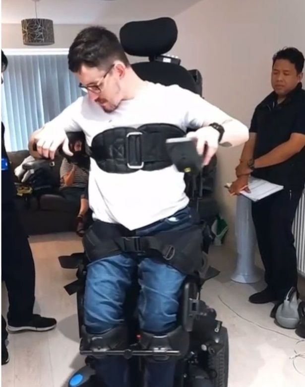 Dylan trialling the standing wheelchair with occupational therapists