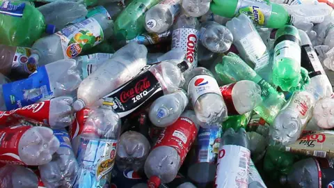 PA Media Generic picture of a pile of plastic soft drink bottles