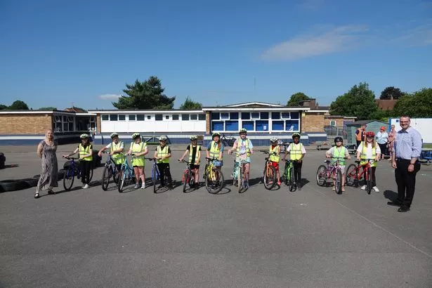 Children at Rokeby Park Primary School during a Bikeability training session with Councillor Tracey Henry (left) and Councillor Mark Ieronimo (right)