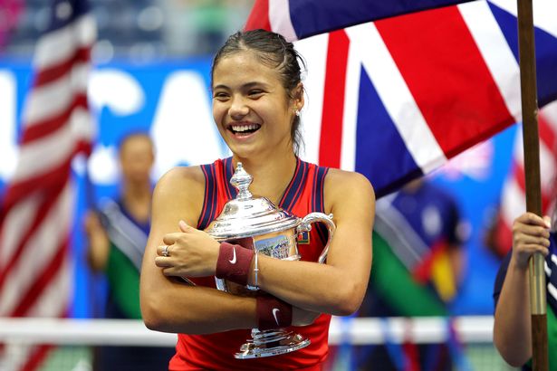 Emma Raducanu clutching her US Open trophy