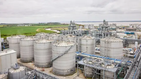 PA Media/Vivergo An aerial view of the facility in Saltend. There are nine large metal spherical structures and silos, along with associated pipework. There is an estuary in the background.