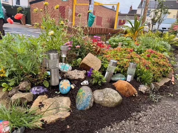 The rockery garden with hand-painted stones contributed by local children