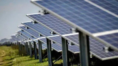 PA Media Stock image of solar panels in a field.