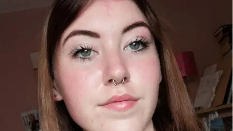 Family handout A teenage girl with shoulder length, brown hair. She has a pale complexion and is wearing a nose ring.
