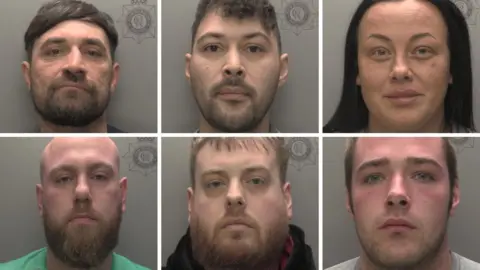 Humberside Police A composite image showing police custody photos of six people arranged in two rows of three. The pictures show head and shoulder images against grey backgrounds. Top row, from left: A man with black hair and beard; a man with short curly brown hair and beard; a woman with long black hair. Bottom row, from left: A man with a shaved head and full brown beard wearing a green T-shirt; a man with short fair hair and full beard wearing a black top; a man with short fair hair and closely cropped beard wearing a light-grey T-shirt. 