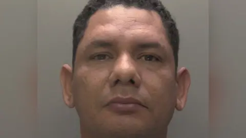 NCA Custody photograph of Didier Reyes he has short black hair and is wearing a grey T-shirt