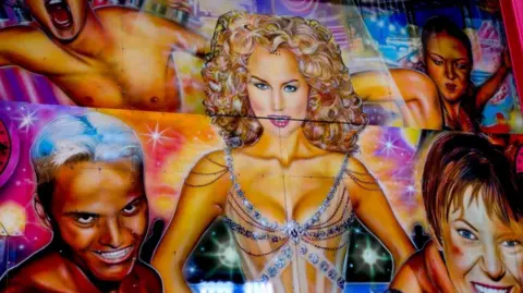 Keaton and George Brignall McDougall A highly colourful airbrushed artwork featuring a a blonde woman wearing a bejewelled leotard, she is surrounded by four other figures against a kaleidoscopic background.