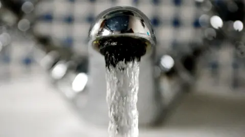PA Media A close up of a tap with running water