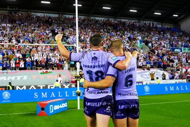 Jack Broadbent and Mikey Lewis celebrate after Hull KR's win over Wigan Warriors.