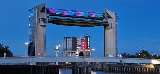 The Tidal Barrier lit up pink and blue in 2023