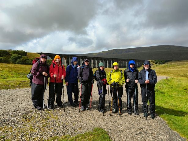 A brief respite from the rain between summits – the team at the Ribblehead Viaduct during the Yorkshire Three Peaks challenge
