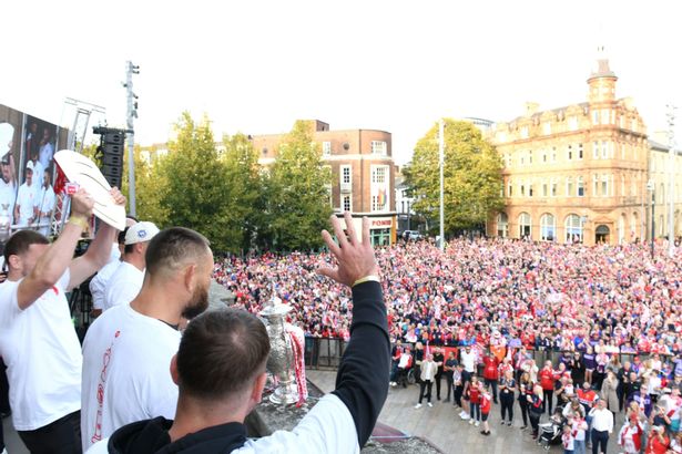 Hull KR players celebrate with their supporters in Queen Victoria Square 