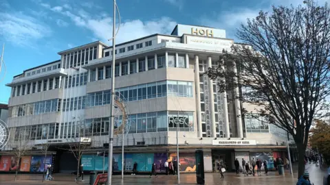 Garness Jones A large building in Hull city centre. It has lots of windows and is opposite Hull train station. The architecture is impressive and Hammonds of Hull is written on multiple signs, however the bottom floor os boarded up and hasn't been occupied for three years. 