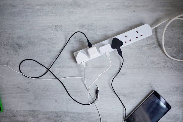 Digital tablets and mobile phones plugged in to an extension lead charge