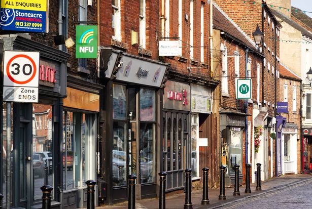 Selby, UK - January 17, 2025: A row of shops with various signs in the northern town of Selby in Yorkshire, UK.