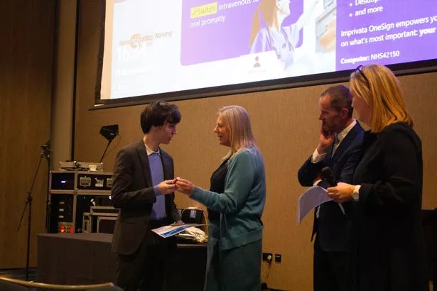 Harry Ross receives his award from Victoria Bagshaw
