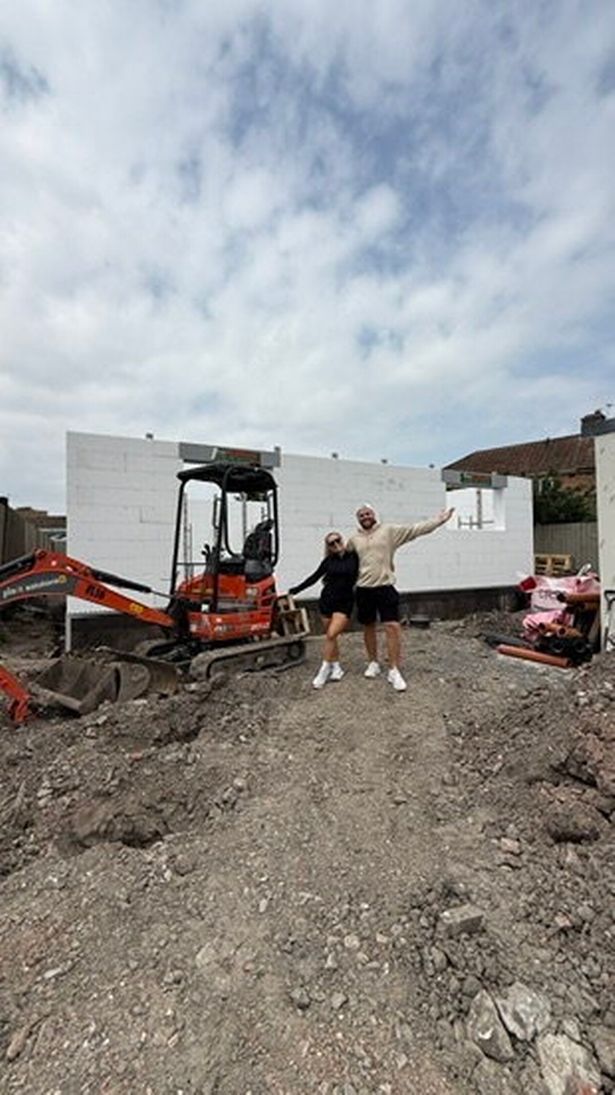 Hannah and Charlie alongside their house during construction