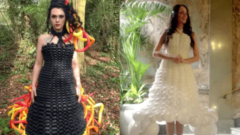 Neil Barnby/Designer wAIR Two photos side by side. In one photo a young woman wears a black full-length dress made out of balloons. At the bottom of the dress and in her hair are stripes of red, organge and yellow balloons. She is standing in a woodland area with a tree behind her. She is looking to the camera. In the other photo a woman with long brown hair poses in a bridal balloon dress. The dress is made entirely of white balloons.