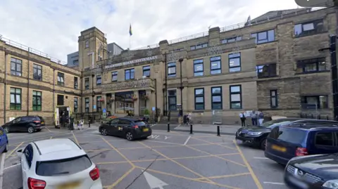Google The entrance of Bradford Royal Infirmary with cars parked outside 
