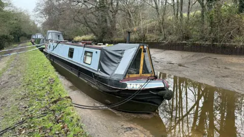Phil Johnson A narrowboat in a very shallow amount of water