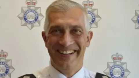 Humberside Police Paul Anderson, former chief constable of Humberside Police, smiles into the camera. He has grey hair and is wearing a white uniform