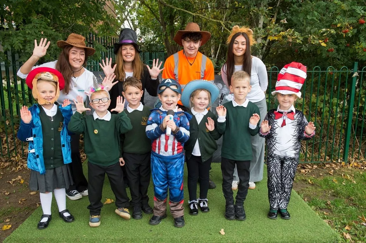 The project included the creation of a new outdoor theatre space for teaching and performing. Siemens Mobility colleagues, Maddy Barker, Clare Thornton, Tristan Masterman and Phoebe Taylor are pictured with children enjoying the new space. Credit: Sean Spencer, Hull News and Pictures.