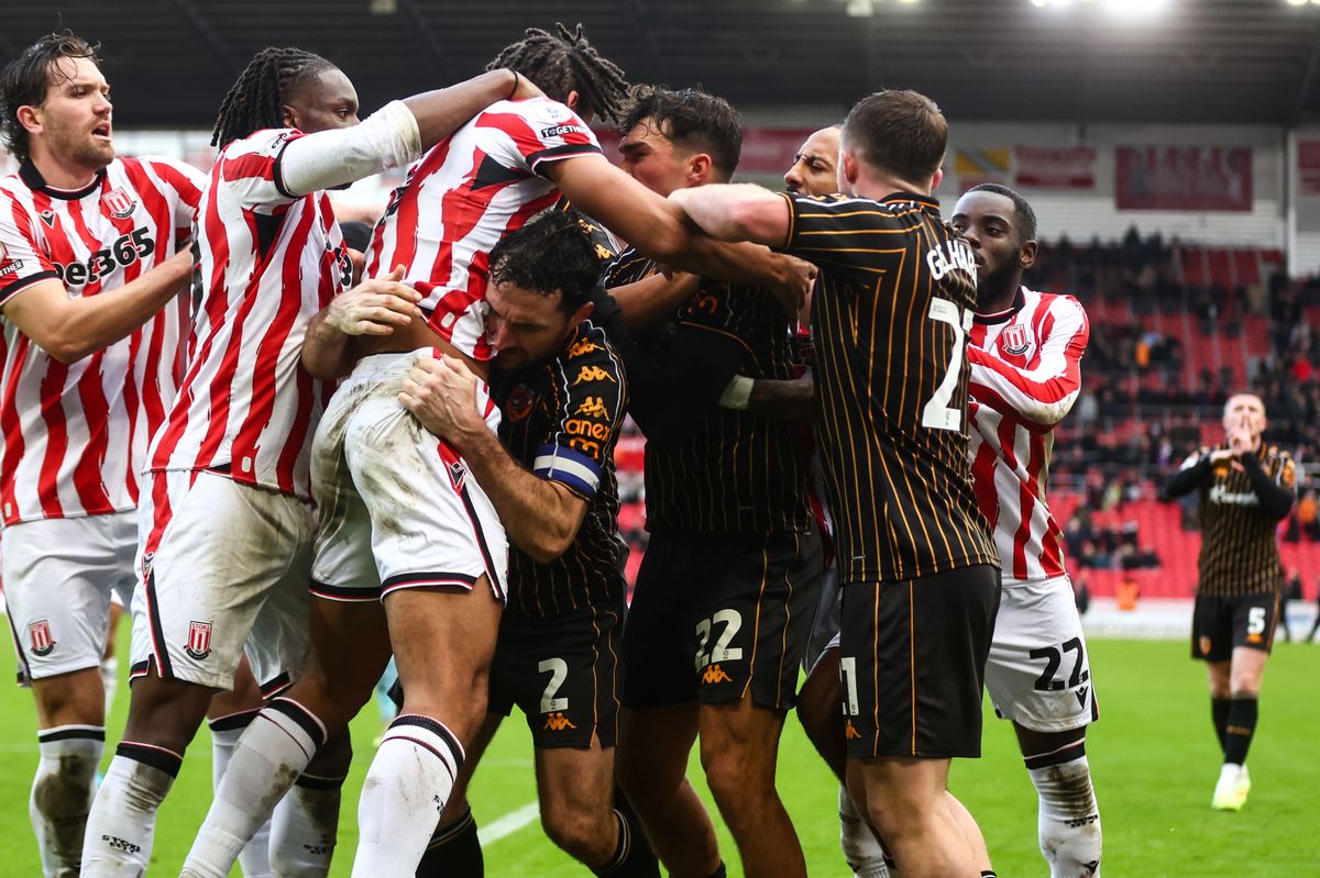 Stoke City and Hull City's players clash while John Lundstram watches on in the background