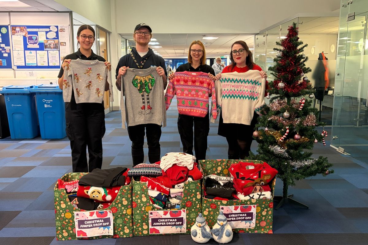 Members of the Love Your Street team with the 145 donated Christmas jumpers.