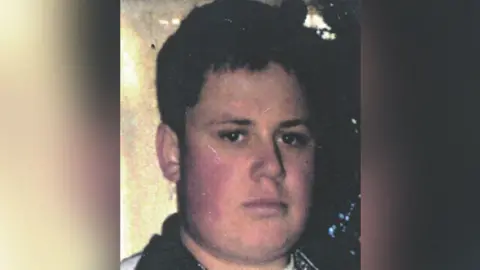 Missing People handout Philip Fudge, who went missing as a 21-year-old, is photographed with short brown hair and brown eyes while wearing a jumper with black collar.