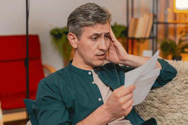 A man reading a letter