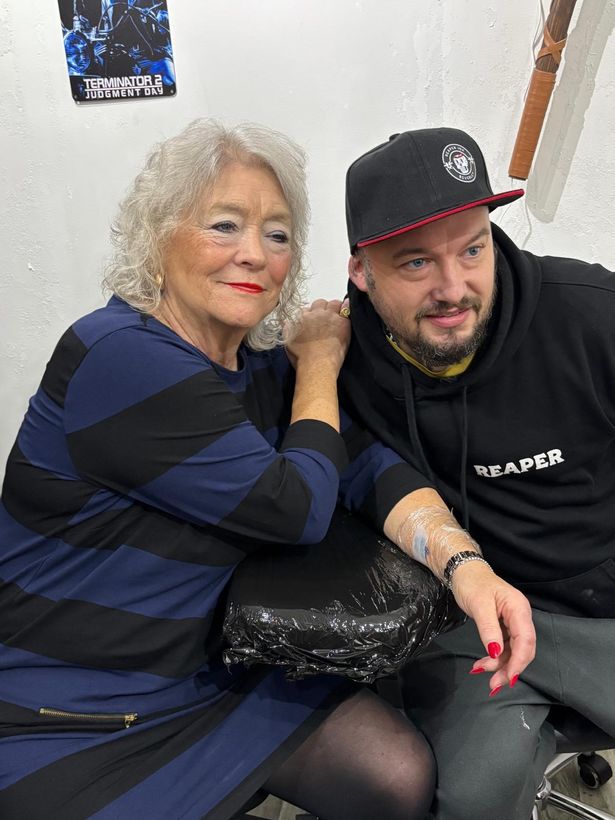 Trish with Nick of Reaper Ink just after getting the forget-me-not tattoo on her inner arm