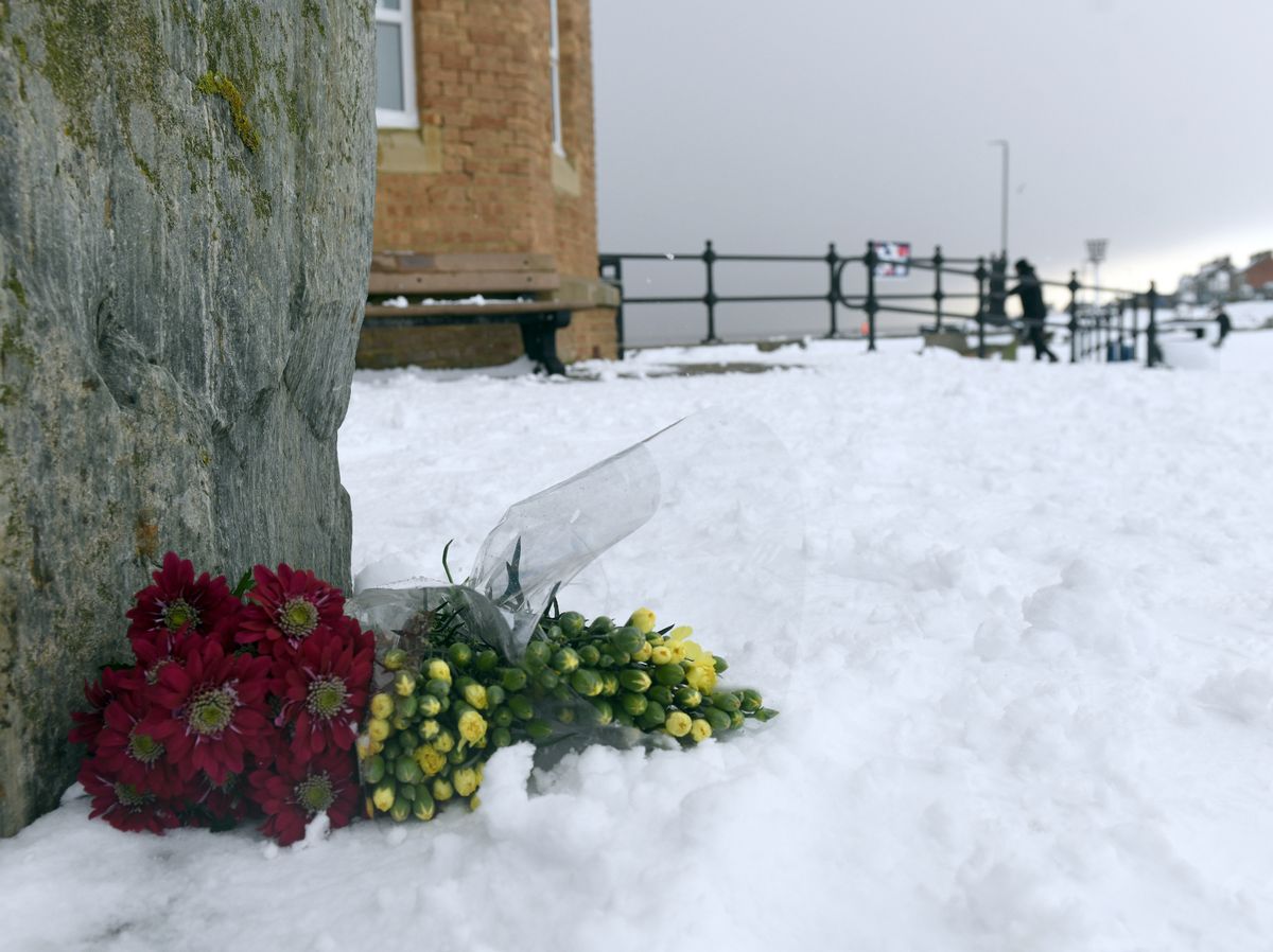 Flowers placed in the snow by Pier Towers, Withernsea, after the tragedy