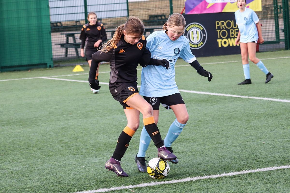 Game on - Hull City (represented by South Hunsley School) and Harrogate Town (represented by St John Fisher Catholic Academy) players fight for the ball