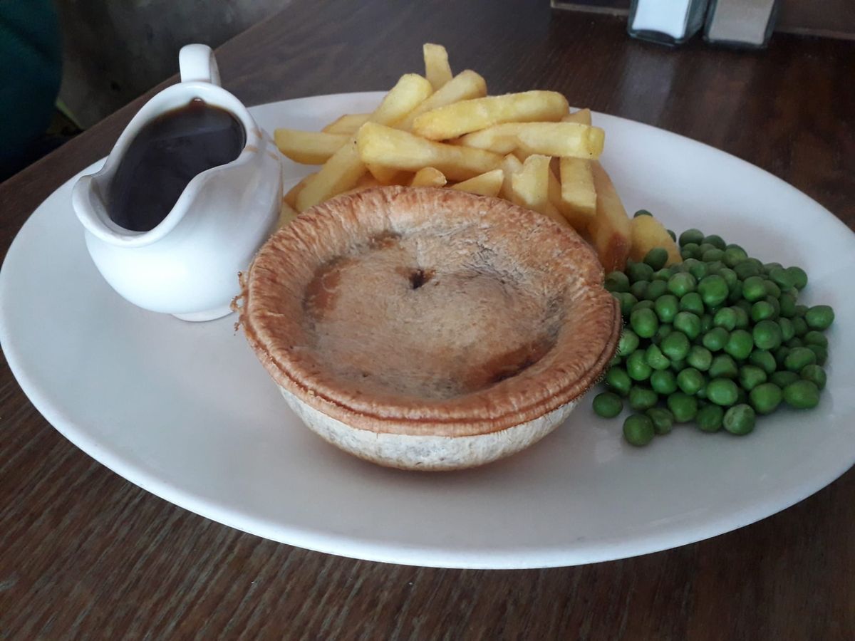 Steak and Ale Pie with a side of chips, peas, and gravy