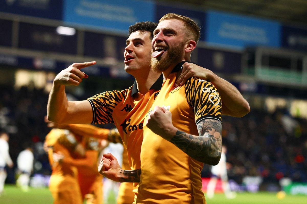 John Egan and Oli McBurnie celebrate Hull City's third goal at PNE