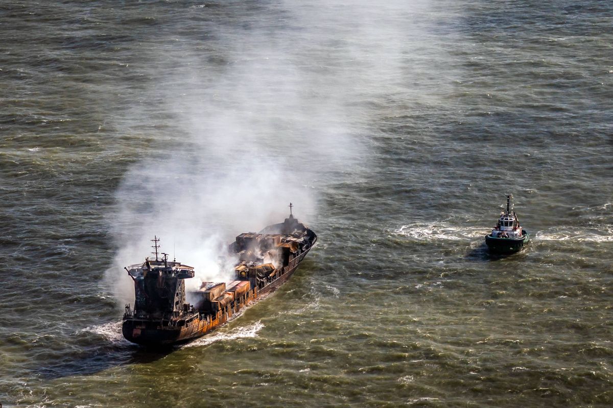 File photo dated 11/03/25 of a tug boat shadowing the Solong container ship as it drifts in the Humber Estuary, off the coast of East Yorkshire after it was involved in a collision with the anchored tanker Stena Immaculate about 12 miles off the coast of East Yorkshire on March 10, in the North Sea. A jury has been sworn in at the Old Bailey for the manslaughter trial of a Russian ship captain accused over the death of a crew member in a crash near the Humber Estuary. Issue date: Tuesday January 13, 2026.