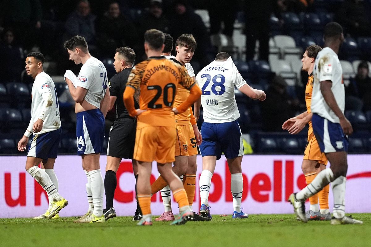 Preston’s Milutin Osmajic, centre right, turns away with his shirt pulled over his head after being shown a red card against Hull