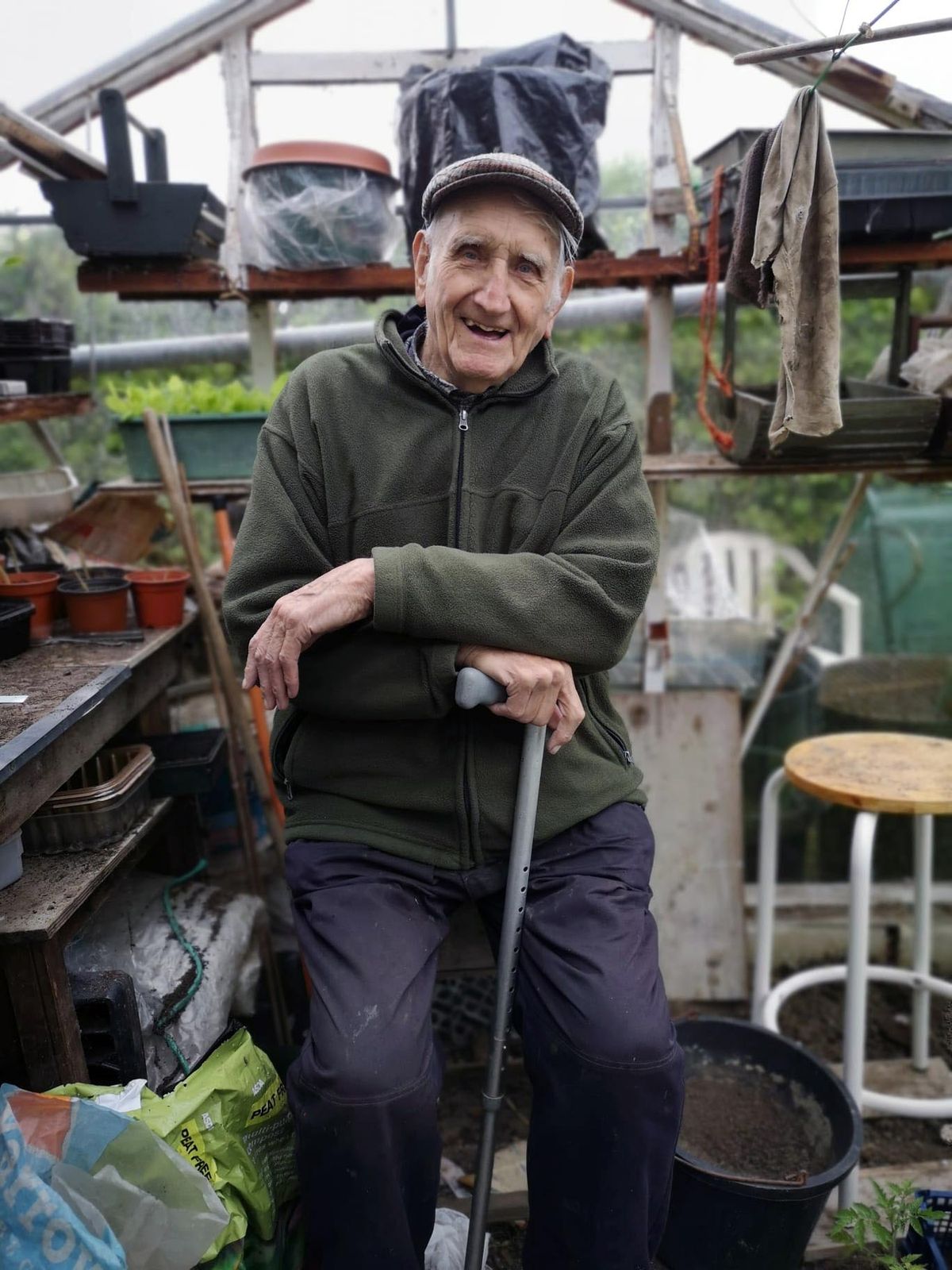 Harry Buck sat in his greenhouse