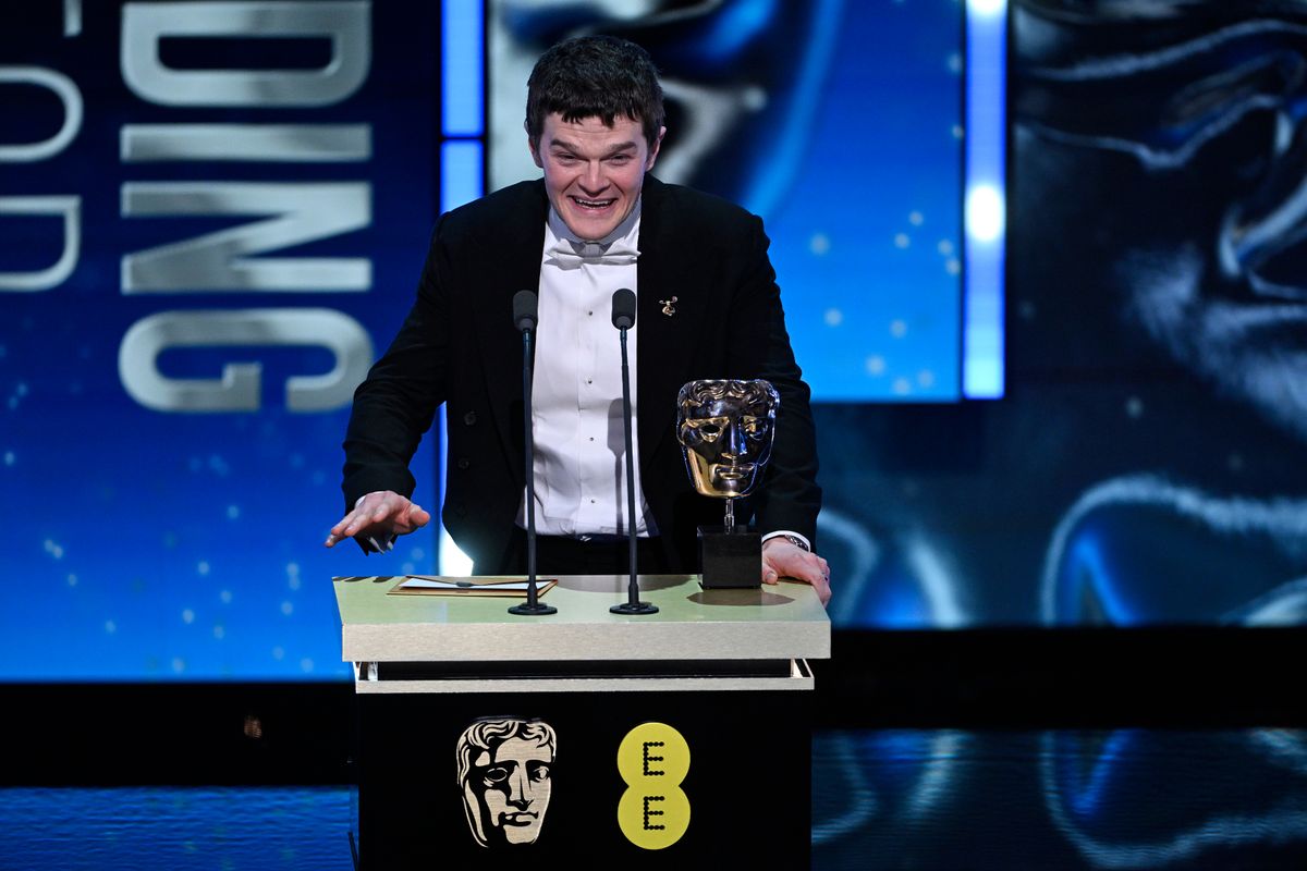 Robert Aramayo accepts the Leading Actor Award for 'I Swear' on stage during the EE BAFTA Film Awards 2026