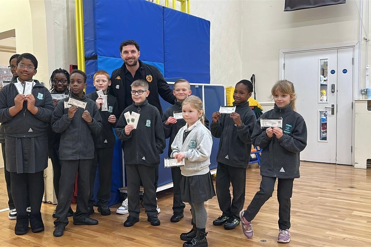Lewie Coyle with students at St George's Primary School after handing out Hull City vs Chelsea tickets