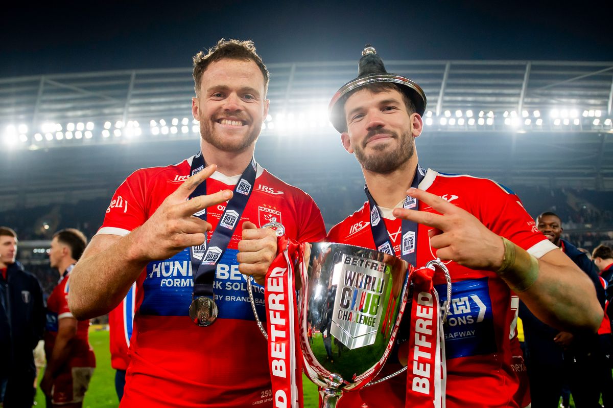 Hull KR's Joe Burgess and Oliver Gildart with the Betfred World Club Challenge trophy after victory over Brisbane Broncos.
