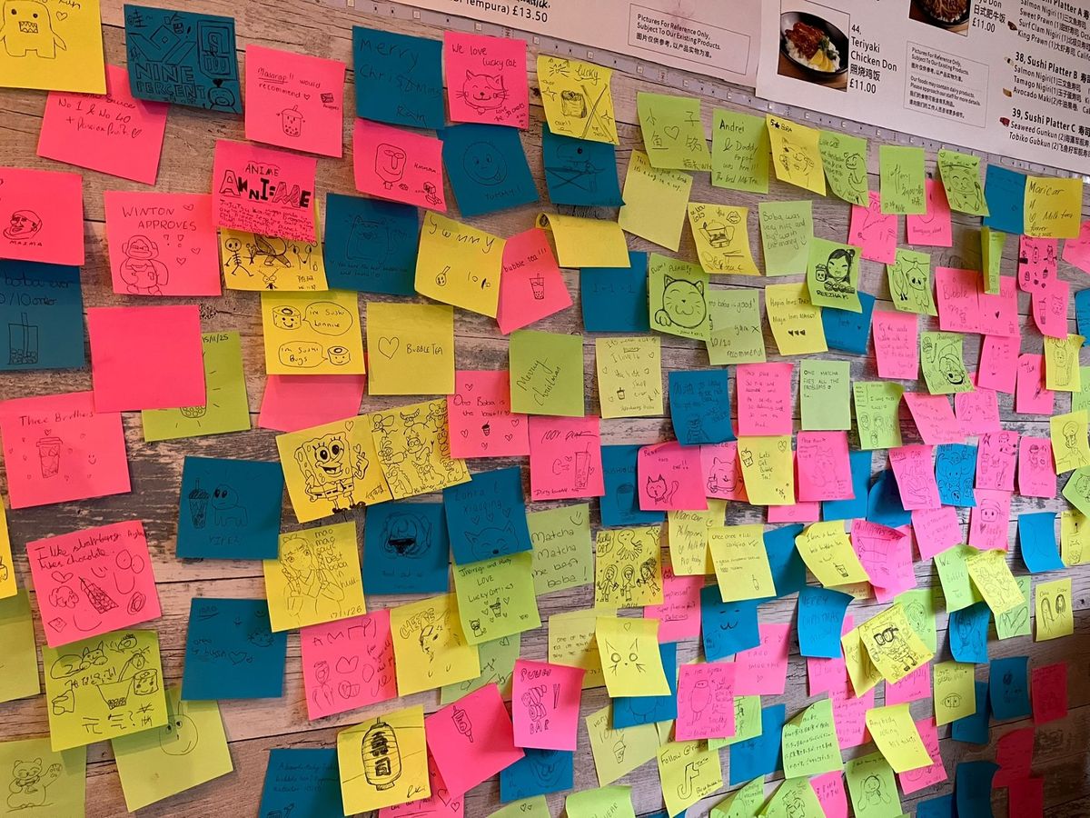 The wall of post it notes left by customers