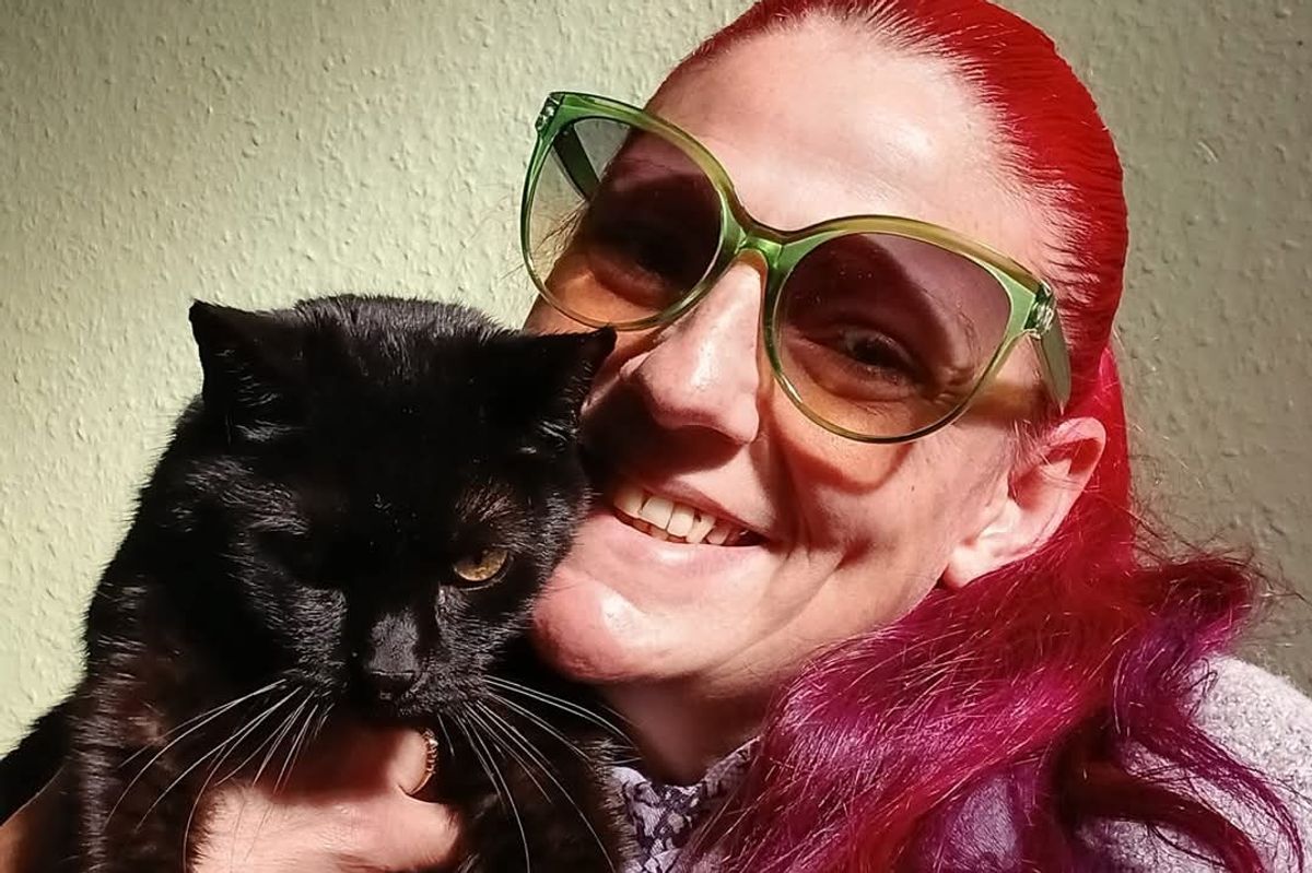 Amy Donoghue with one of the cats in her care at Never Give Up Rescue CIC