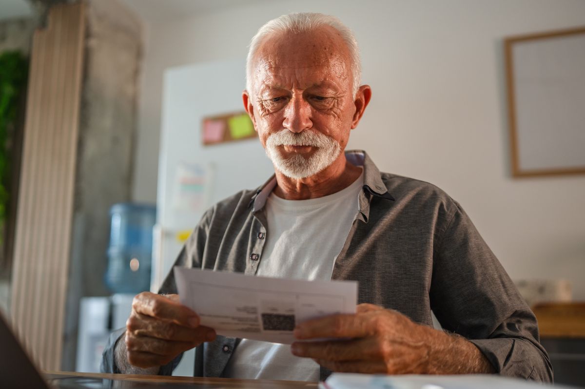 Man reading bills