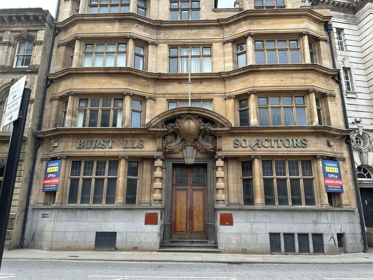 Most of the "Burstalls Solicitors" lettering remains on the building