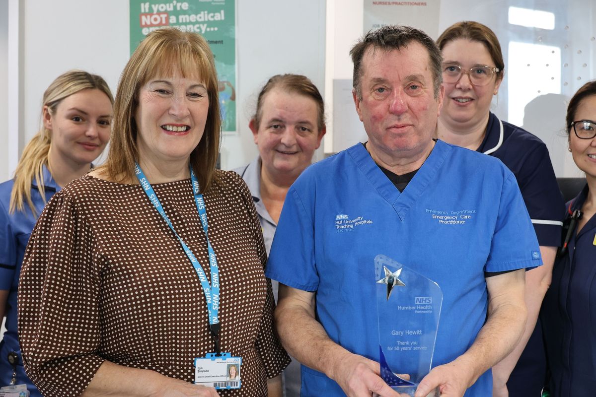 Gary Hewitt with interim chief executive Lyn Simpson and the award he received for his service