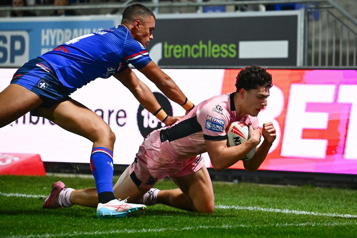Corey Hall of Wakefield fails to stop Lewis Martin of Hull FC from scoring a try