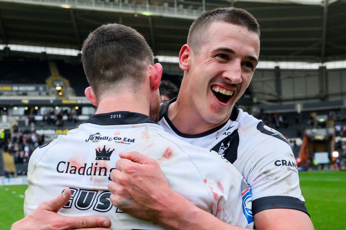 Hull FC half-back Jake Arthur celebrates victory with Cade Cust.